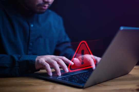 Businessman Or It Staffs, Programmer, Developer Using Computer Laptop With Triangle Caution Warning Sign For Notification Error And Maintenance Concept. Hack System Alert, Warning Computer System