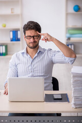 Young male employee working in the office