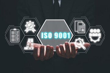 ISO 9001 concept, Businessman hand holding iso 9001 icon on virtual screen.