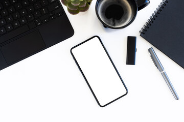Top view office table desk. smartphone with a blank screen, keyboard, office supplies
