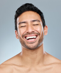Fototapeta premium The secret behind looking your best is feeling your best. a handsome young man posing against a grey background.