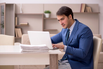 Young male employee working from home during pandemic