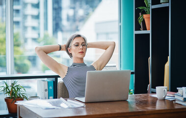 I use online tools that help me to keep things controlled. a businesswoman looking laid back while sitting at her desk.