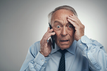 My bearer of bad news has the worst timing. a senior businessman standing alone against a grey...