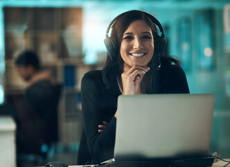 May my existence repeat on you. Portrait of a young woman using a headset in a modern office.