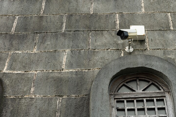 CCTV camera on an old building horizontal composition