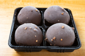 angle view chocolate flavor mochi on a wood table