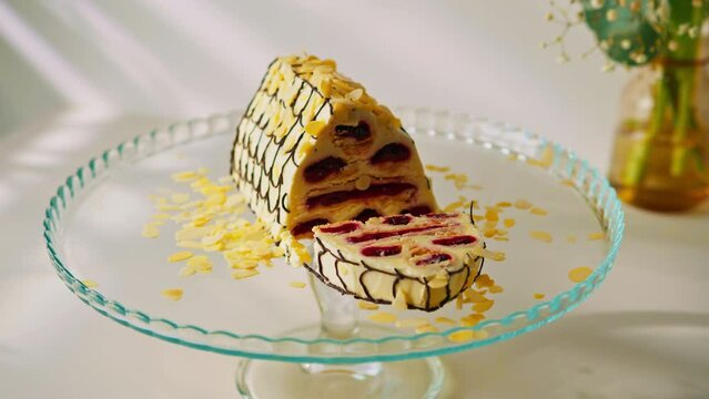 a delicious cherry cake or a monastery hut decorated with almond shavings on a stand cut off a piece