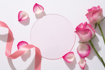 Beauty background with round acrylic sheet form an empty space for display product, fresh roses,...