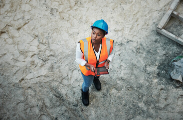The more modern the technology the more streamlined the project. a young woman using a digital tablet while working at a construction site.