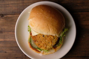 Burger Tempe is burger with tempeh filling. Bun bread, stuffed with processed tempeh, sliced cheese, sliced tomatoes, lettuce, mayonnaise, and tomato sauce. healthy burgers, suitable for vegans. Diet