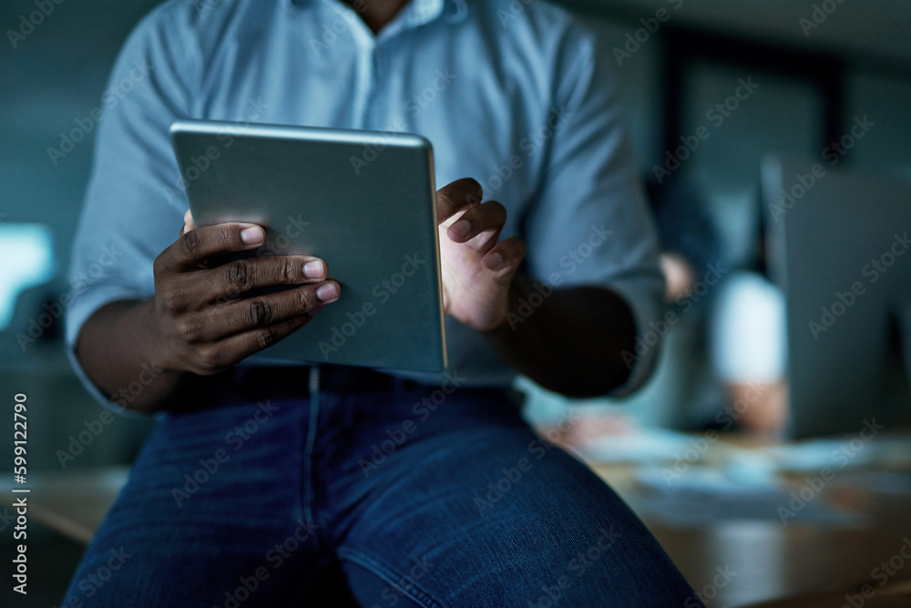 Aufkleber Smart apps keep things streamlined and efficient. an unrecognisable businessman using a digital tablet during a late night at work.