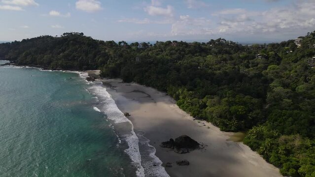 Drone view flying over the coast before making a panoramic shot of the sand, Costa Rica