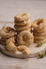 Cheese cookies on a white wooden table. Cookies are dry bread baked in the oven, made from wheat flour, eggs, sugar, cheese and other ingredients. White cheese cookie. sagu keju. sagoo cheese. 