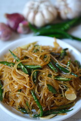 soy sauce seasoned vermicelli noodles with sliced green chilies. Vermicelli are fine noodles made from starch. sohun pedas. 