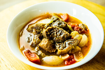 Spicy shanks soup in bowl, in door Chiangmai Thailand.