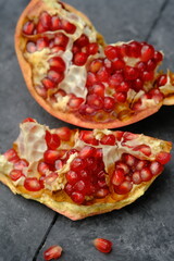 pomegranates are a staple of the diet. red pomegranate on a black table