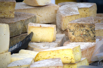 different types of hard cheese on a farmers market