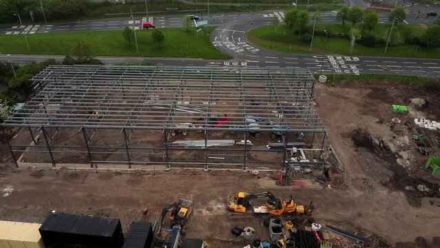 ALDI supermarket construction building site aerial view rising up over industrial framework development, UK