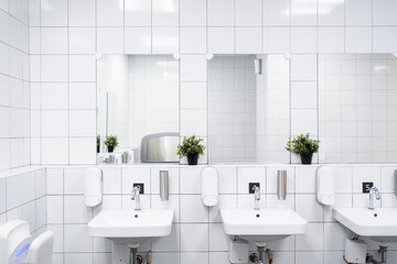 White colour ceramic tiles toilet hand wash area. White colour theme toilet interior. Cleanliness concept. Clean toilet concept.