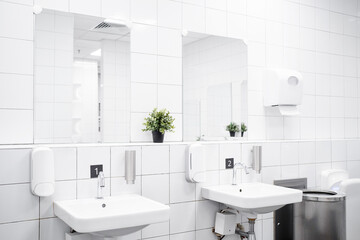 White colour ceramic tiles toilet hand wash area. White colour theme toilet interior. Cleanliness concept. Clean toilet concept.