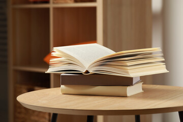 Stack of different books on wooden table indoors, space for text
