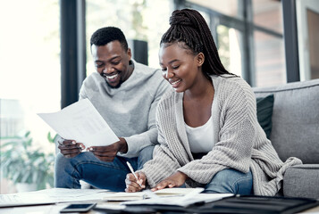 Were never more wealthy than when were financially free. a young couple going through paperwork at...