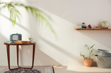 Vases and objects on the table in a warm room with sunlight coming in