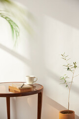 Vases and objects on the table in a warm room with sunlight coming in