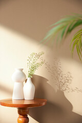 Vases and objects on the table in a warm room with sunlight coming in