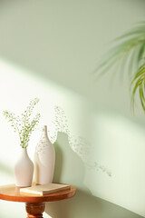 Vases and objects on the table in a warm room with sunlight coming in