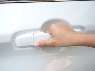 Young woman hand opening car door.