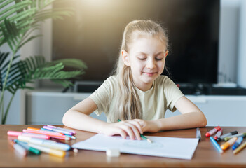 Child girl drawing with colorful pencils