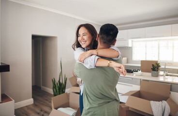Property, happy couple moving into their new home and boxes in living room. Happiness or smiling, mortgage or homeowners and people hugging celebrating with their new house or apartment together