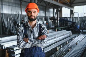 Factory worker measures the metal profile