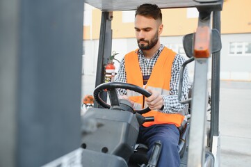 Waving forklift driver in the warehouse of a haulage company while driving forklift