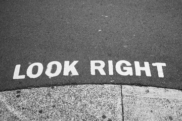 Look right sign painted on road advising care when stepping of path