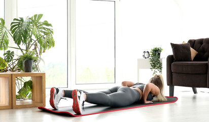 Strong Athletic Fitness Girl in Sportswear is Doing Exercises in Her Bright Living Room. 