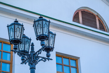 Fototapeta na wymiar Old lamps on a lighting pole near the house.