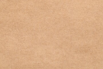 Fototapeta na wymiar Texture of beige paper sheet as background, top view