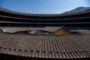 Fototapeta na wymiar Close up on The roofs of the buildings inside Fujian earthen buildings (also known as Hakka tulou) in mountains. These buildings are in Chuxi village.