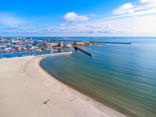 Aerial view landscape. Urban beach in Poland, Gdynia. Photo from a drone. View of the harbor and marine. Baltic Sea.