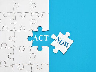 Act now, text words typography written on jigsaw puzzle, life and business motivational inspirational