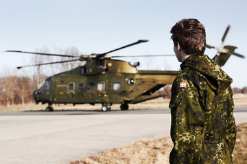 Army, military or soldier man with a helicopter outdoor for transportation, Denmark war and pilot...