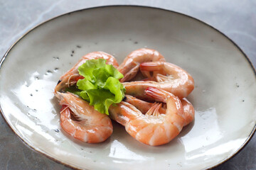 Shrimps with salad  in a plate on the table. High angle view.
