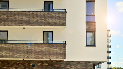 Modern apartment buildings on a sunny day with a blue sky. Facade of a modern apartment building. Contemporary residential building exterior in the daylight. 