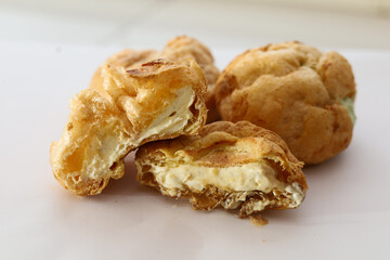 Choux Cream on a white background.  Profiteroles, Eclairs, cream puffs