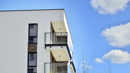 Modern apartment buildings on a sunny day with a blue sky. Facade of a modern apartment building. Contemporary residential building exterior in the daylight. 