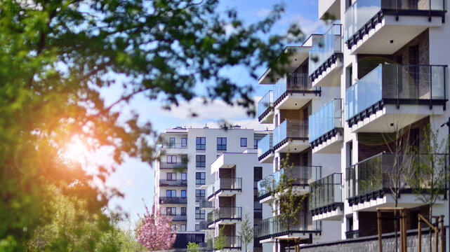 Modern apartment buildings on a sunny day with a blue sky. Facade of a modern apartment building. Contemporary residential building exterior in the daylight. 