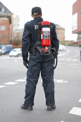 Emergency, police and man safety officer or fireman working a neighborhood street feeling fearless...